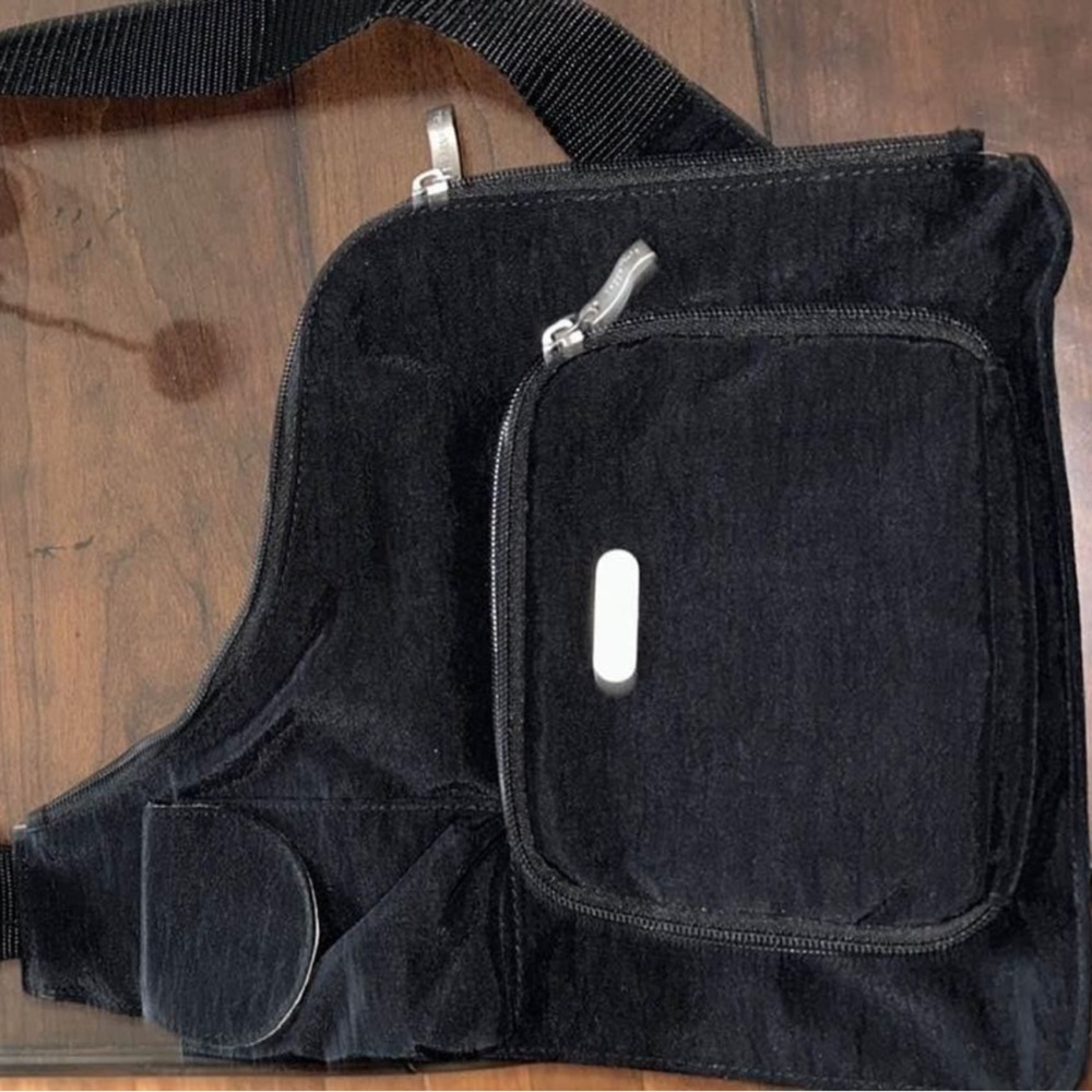 Baggallini over the sling side bag . Black new without tags . Retails for $90